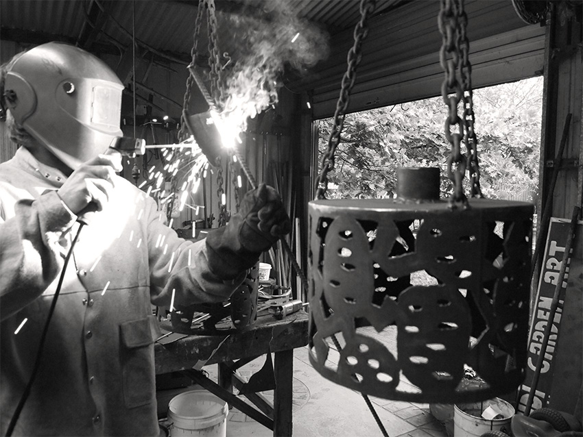 Sam Larwill welding his metal work.